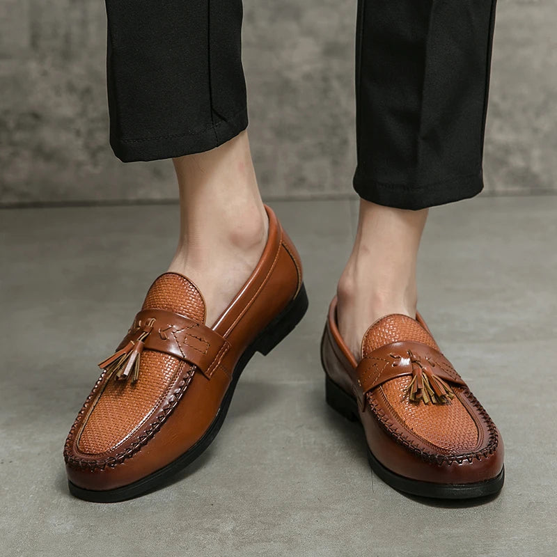 Polished men's black woven tassel loafers. Elegant slip-on footwear, offering classic style and comfort for any occasion.