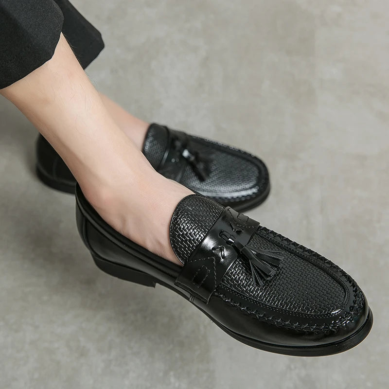 Elegant men's navy blue woven tassel loafers. Slip-on formal footwear for a sophisticated and polished classic style.