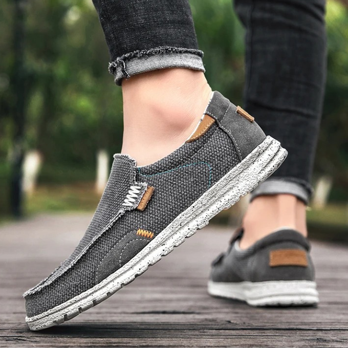 Man in comfortable Dockstone blue slip-on canvas shoes walking, ideal for everyday & easy wear.