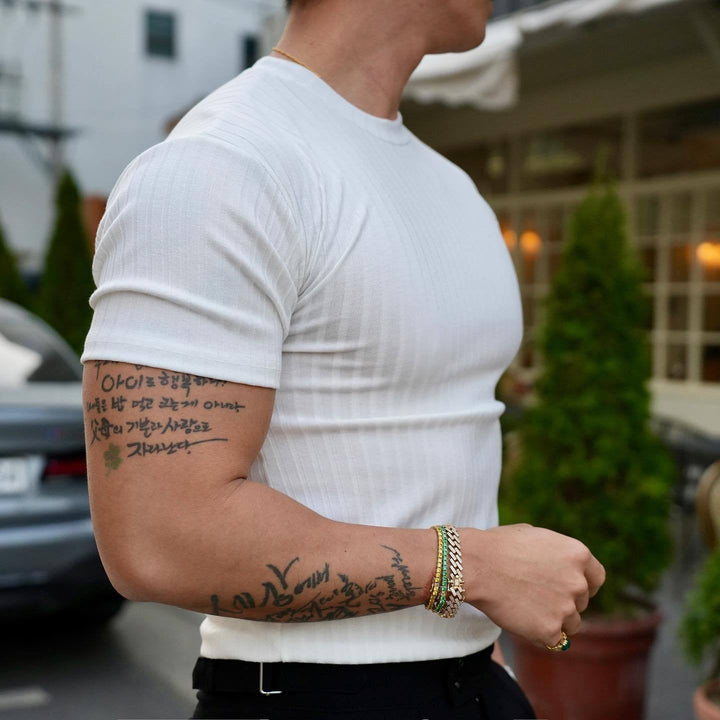 Black men's ribbed slim fit tee, versatile performance wear perfect for casual or athletic activities.