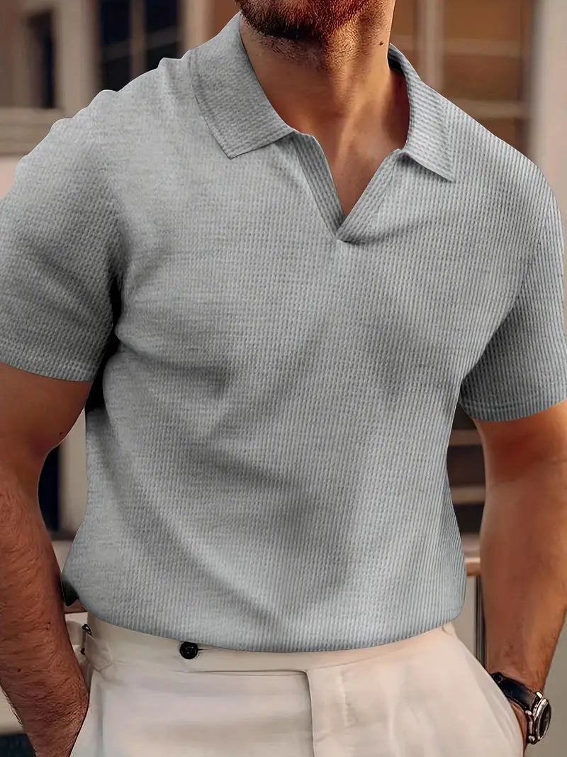 Close-up of a men's ribbed polo shirt, showcasing its textured fabric and modern slim fit. Perfect for summer fashion.