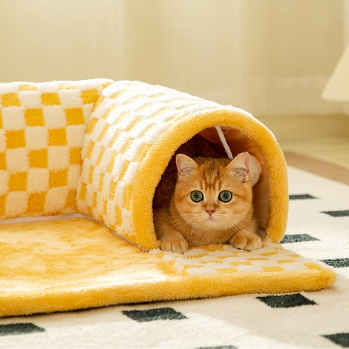 Cat enjoying a cozy rest inside the plaid pet bed tunnel, a versatile cat accessory