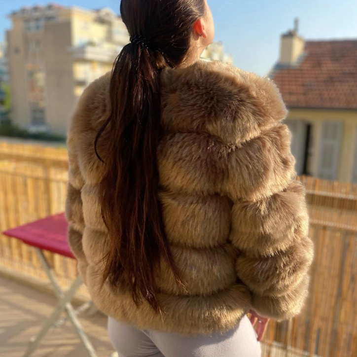 Warm women's plush winter coat, a chic and short design perfect for stylish seasonal layering.