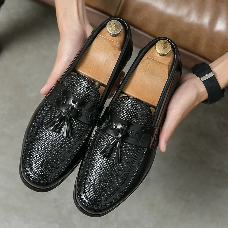 Men's black woven tassel loafers, perfect for polished style or smart casual outfits. Slip-on elegant footwear.