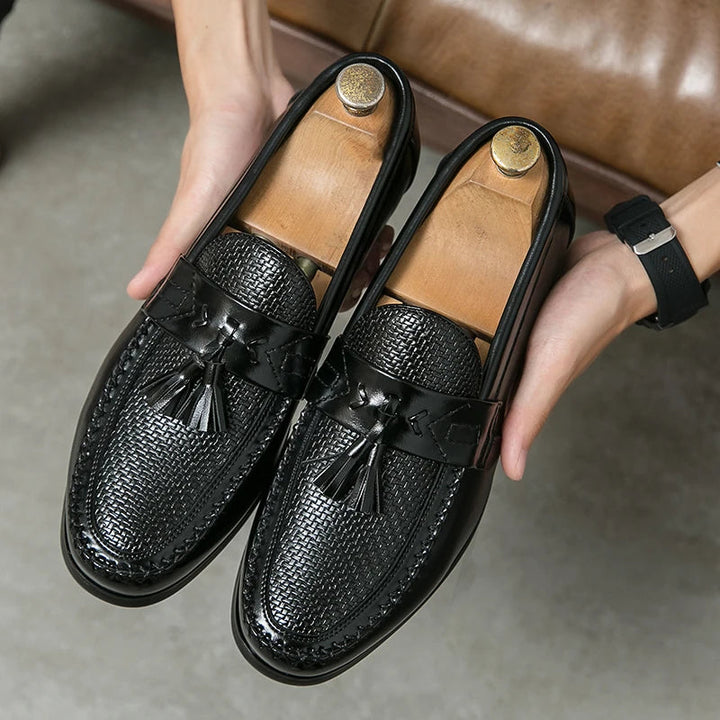 Men's black woven tassel loafers, perfect for polished style or smart casual outfits. Slip-on elegant footwear.