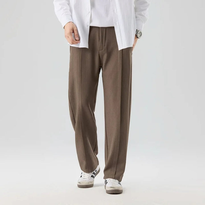 Gray men's pleated drape trousers offering refined comfort & versatile style for modern men.