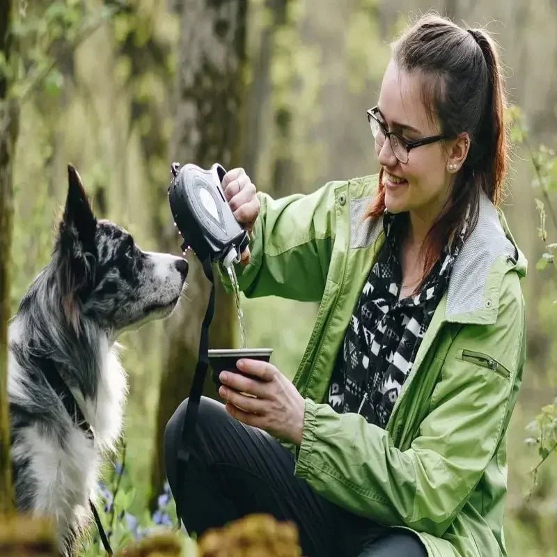 Hands-free pet leash in black nylon, featuring hydration dispenser and built-in waste bag storage