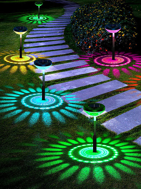 4-pack solar powered LED landscape pathway lights illuminating a garden path at dusk