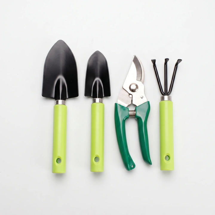 Close-up of an ergonomic trowel, hand rake, and sharp pruning shears from a 4-piece garden tool set.