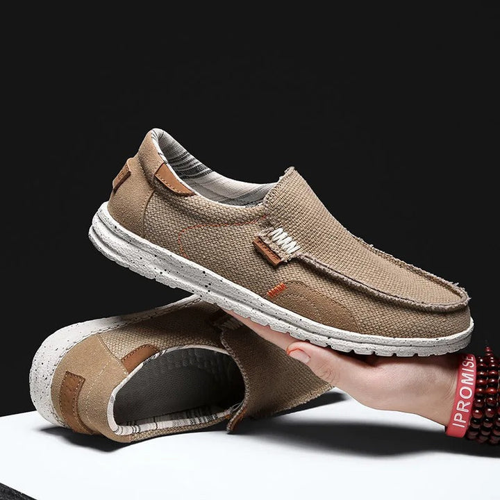 Pair of men's gray Dockstone slip-on canvas shoes, comfortable and durable for everyday casual wear.