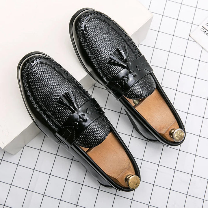 Detailed close-up of men's leather woven tassel loafers. Exquisite craftsmanship for a stylish and elegant fashion statement.