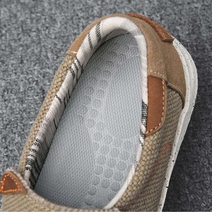 Men's blue Dockstone slip-on canvas loafers on feet, showing their easy wear & casual style.