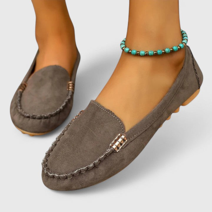 Chic women's slip-on loafers with metal hardware, designed for orthopedic comfort and versatile fashion.