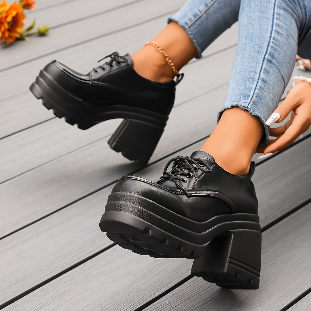 Fashionable women's black platform oxfords, chunky heels, lace-up, adding retro style to any casual dress.