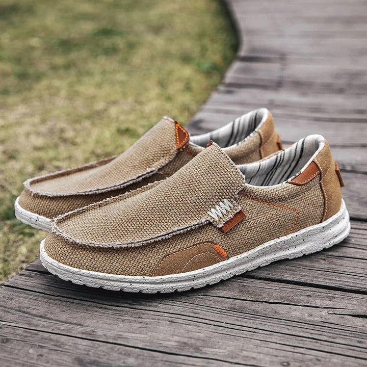 Durable rubber sole of men's Dockstone slip-on canvas shoes, providing comfort & grip for walking.