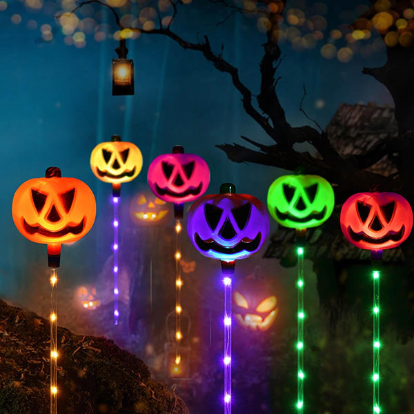 A child admiring 6-pack solar LED Halloween ground lights, adding festive glow to the lawn