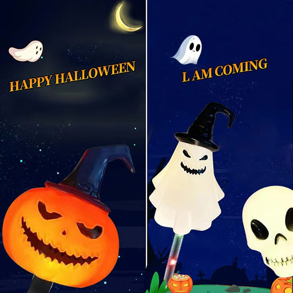 A set of 6 solar LED Halloween ground lights illuminating a garden path at dusk