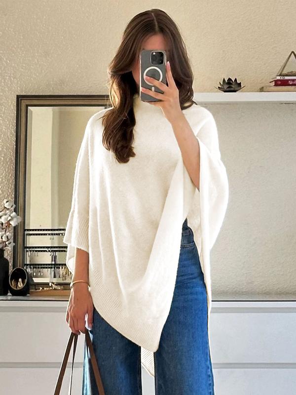 Elegant women's draped knit cape in ivory, featuring an asymmetrical design for versatile layering and comfort.