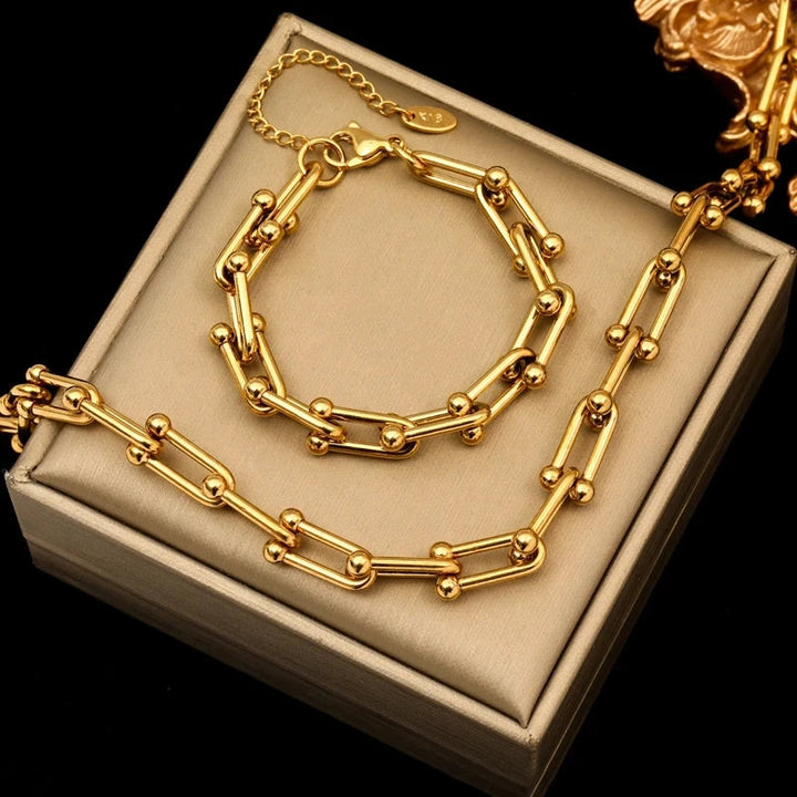 Women's elegant gold link chain jewelry set with a matching necklace and bracelet for a sophisticated look.