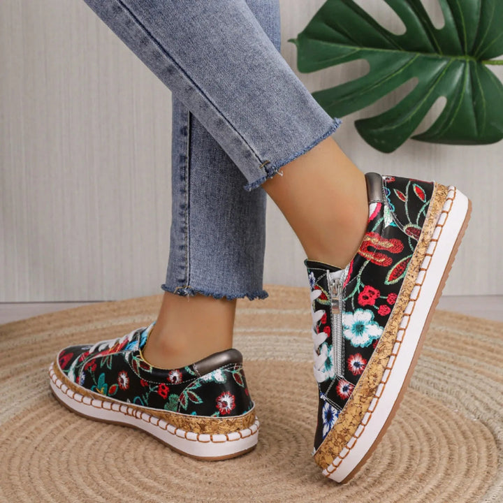 Top view of women's black floral lace-up flat shoes, highlighting the elegant pattern and comfortable design.