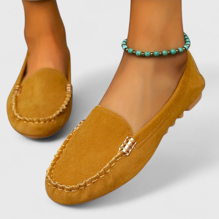 Elegant women's slip-on loafers with chic metal accents, great for office attire or casual wear.