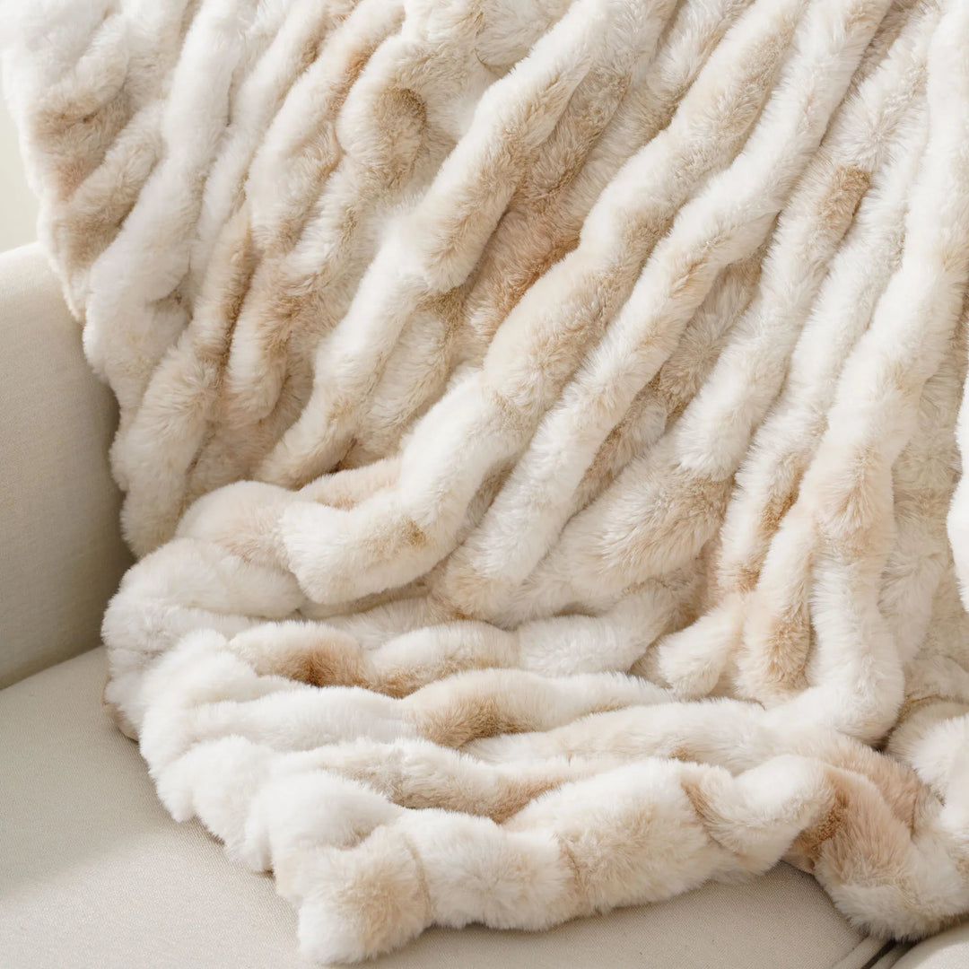 Decorative faux fur throw, a plush and cozy blanket for stylish home comfort.