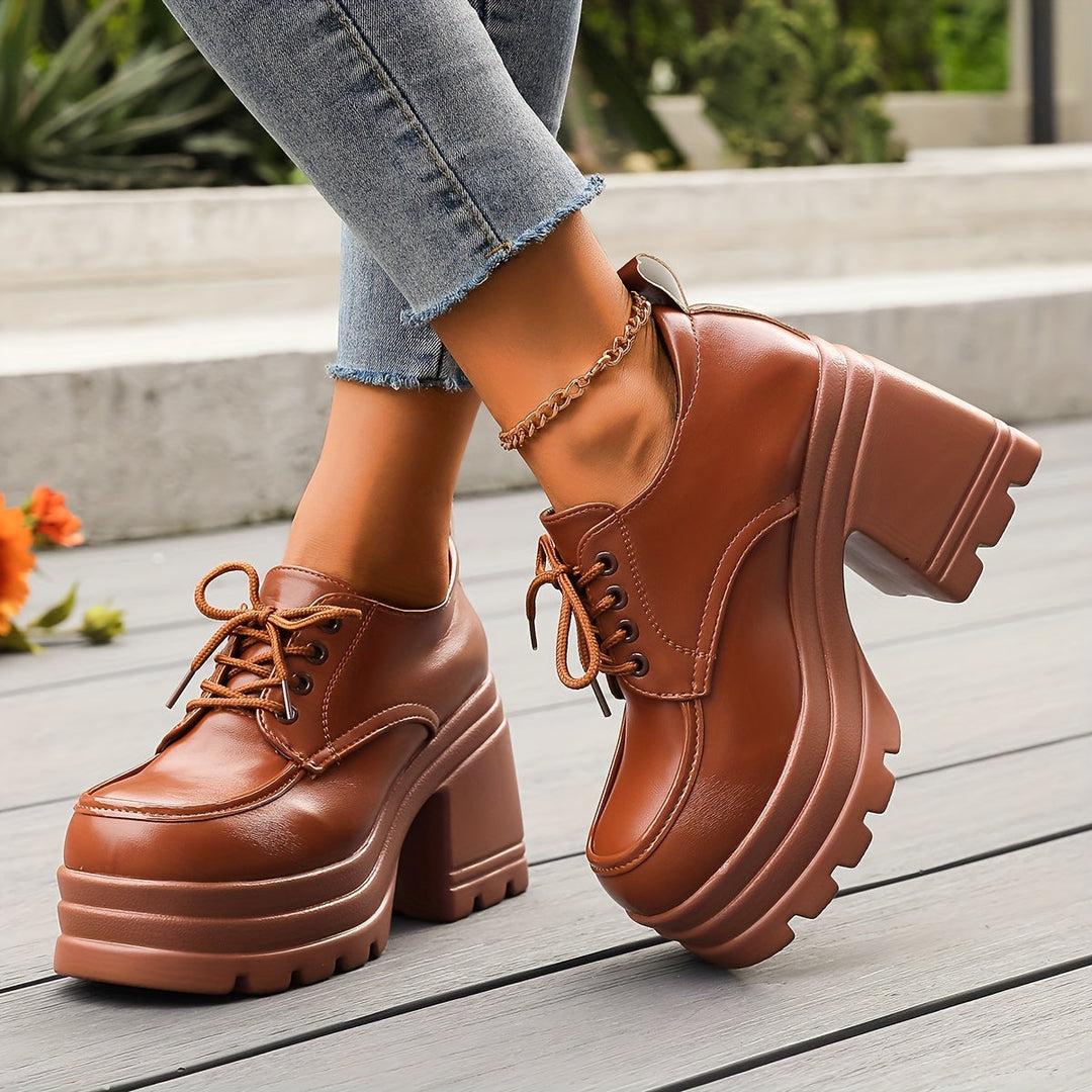 Retro style women's chunky platform oxfords, black lace-up, fashion footwear with a comfortable block heel.
