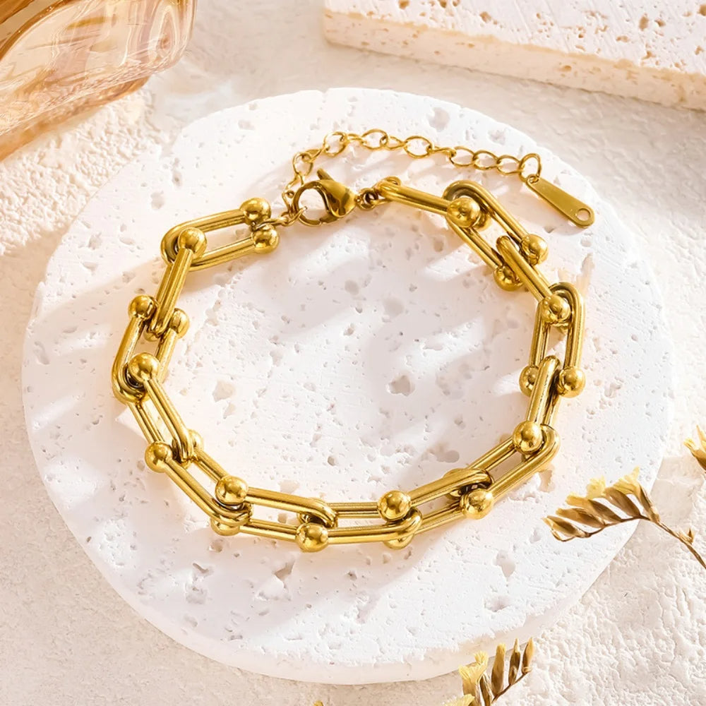Women's gold link chain necklace and bracelet jewelry set, elegant and fashionable accessories.