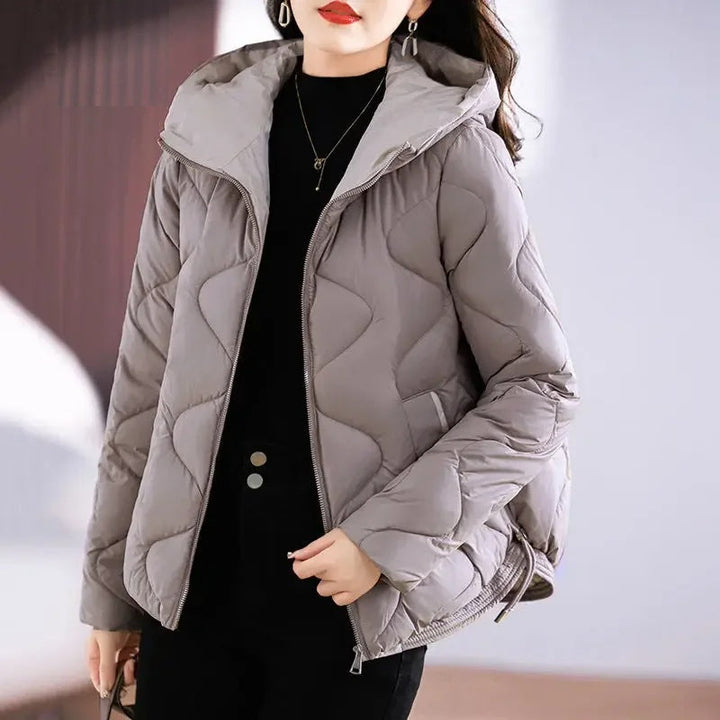 Cozy women's insulated puffer jacket, perfect for stylish fall & winter fashion. Versatile outerwear.