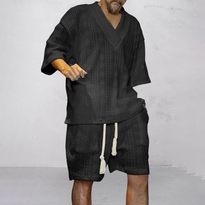 Casual men's V-neck shirt & shorts set, perfect coordinated loungewear for relaxed summer days.