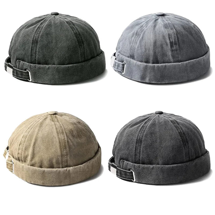 Rolled cuff brimless hat, gray washed cotton, adjustable closure. Essential unisex fashion headwear.