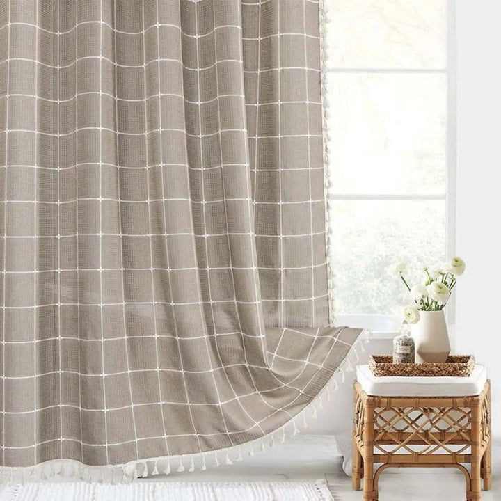 Modern farmhouse linen shower curtain, bohemian aesthetic with tassels for bathroom styling.