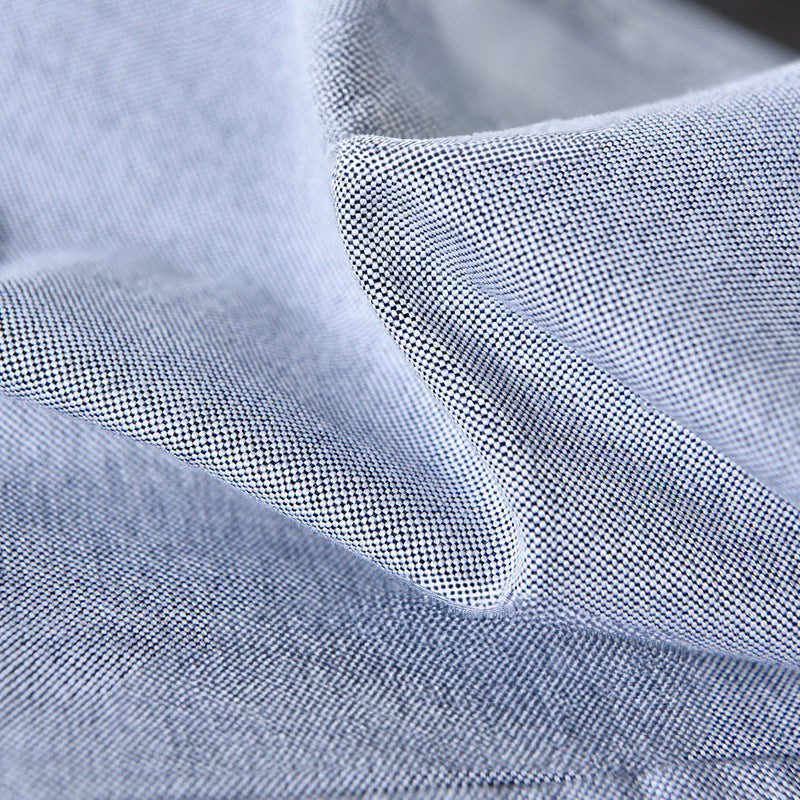 Modern gray men's oxford shirt. Versatile long sleeve button-down for comfortable casual elegance or office wear.