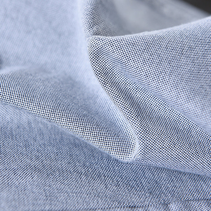 Modern gray men's oxford shirt. Versatile long sleeve button-down for comfortable casual elegance or office wear.