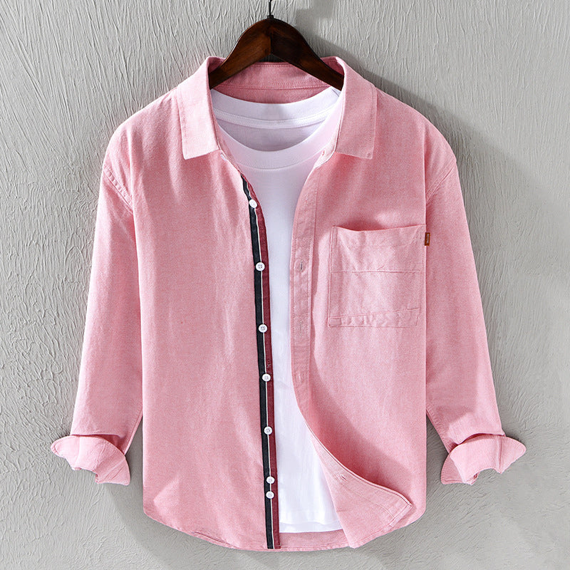 Pink men's long sleeve oxford shirt. Comfortable button-down for versatile casual & professional attire.