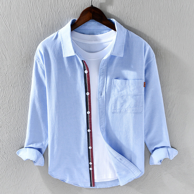 Blue men's oxford shirt. Stylish & comfortable long sleeve button-down for versatile casual & office wear.