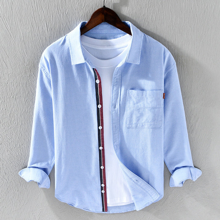 Blue men's oxford shirt. Stylish & comfortable long sleeve button-down for versatile casual & office wear.