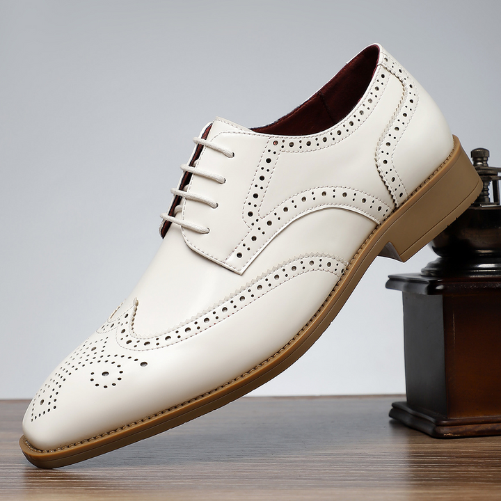 Men's sophisticated black leather brogue wingtip shoes, a versatile choice for formal & business wear.