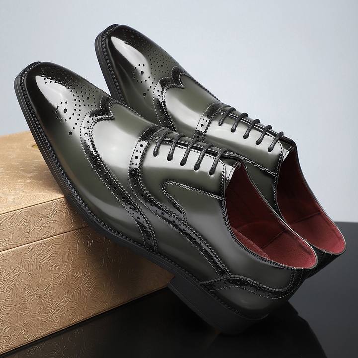 Polished men's formal wingtip dress shoes with classic brogue pattern, perfect for elegant events.