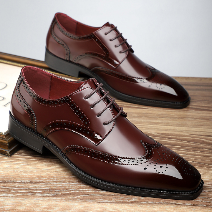 Professional men's wingtip dress shoes with brogue perforations, ideal for office and special events.