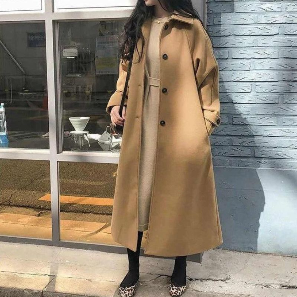 Versatile women's long trench coat, ideal for office wear or chic winter fashion. Classic tailored outerwear.