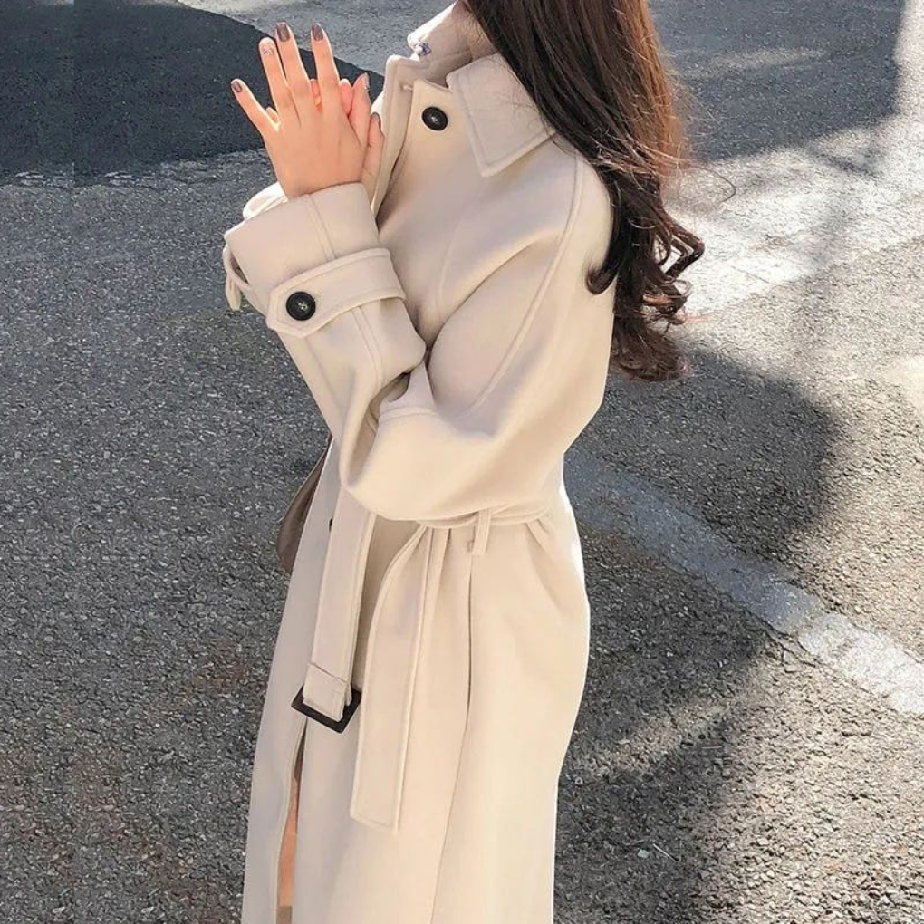 Stylish women's long trench coat, perfect fall outerwear and elegant winter fashion. Classic tailored design.