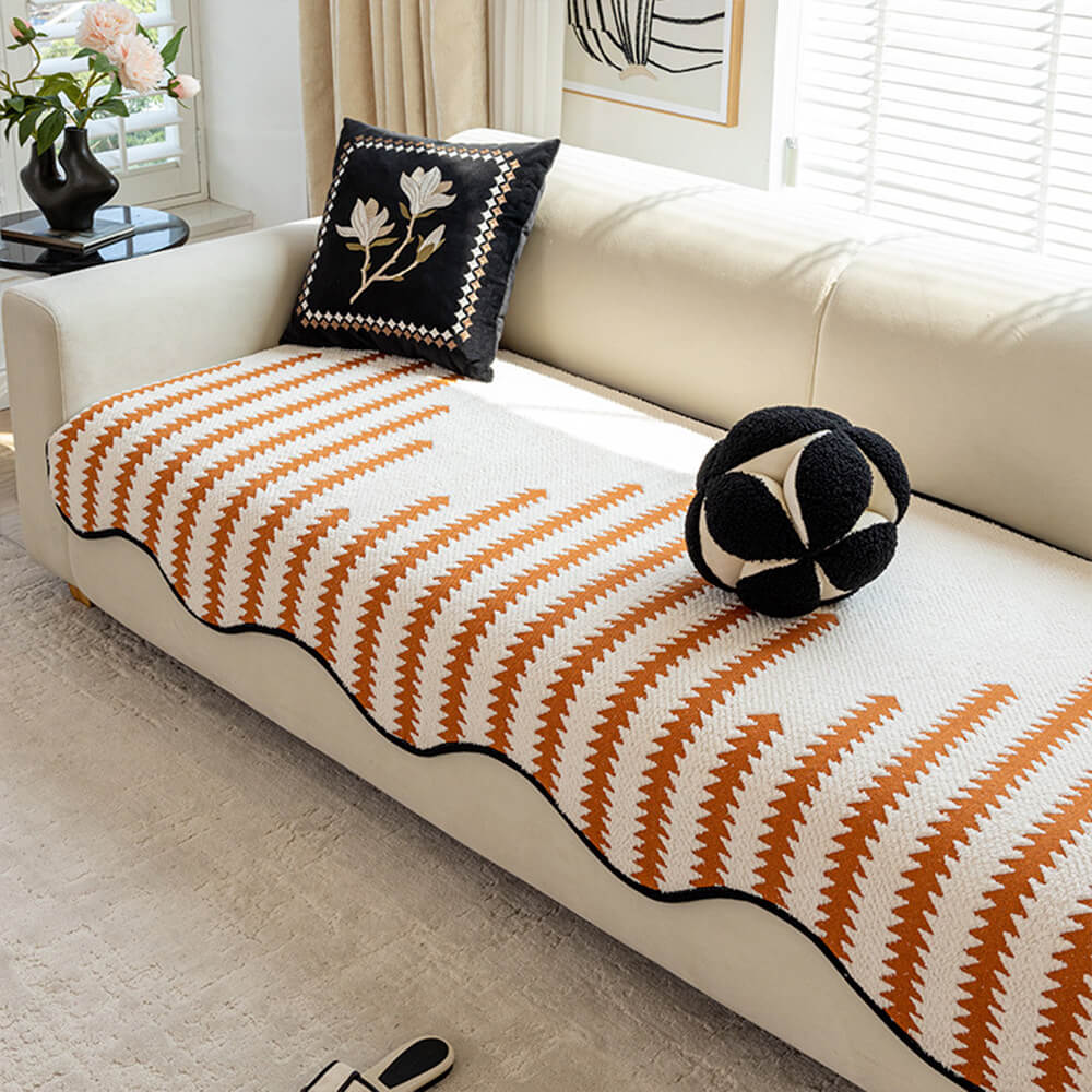 Contemporary chevron sofa protector with wavy edges. Durable, machine washable couch cover for modern living room furniture protection.