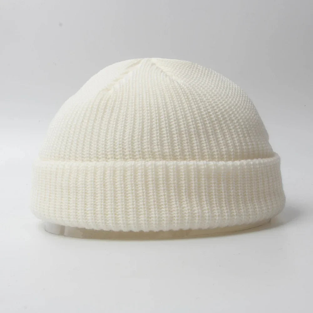 Black unisex knit beanie skull cap, a versatile winter hat for warmth & style.