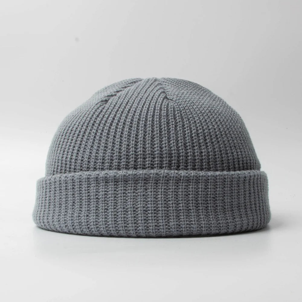 Close-up of a textured knit unisex skull cap beanie, soft & warm winter accessory.