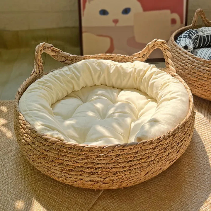 Durable, eco-friendly handwoven rattan cat bed with a soft, washable cushion for pet comfort.