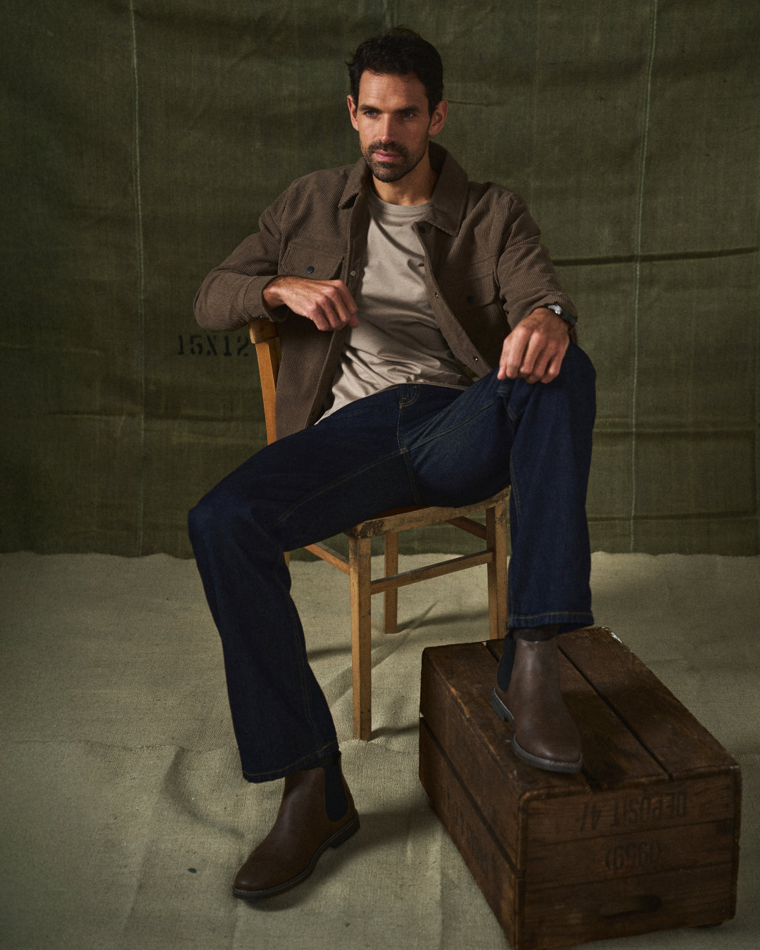 Rear view of men's stylish brown Chelsea boots, showing pull tab for easy slip-on wear & comfort.