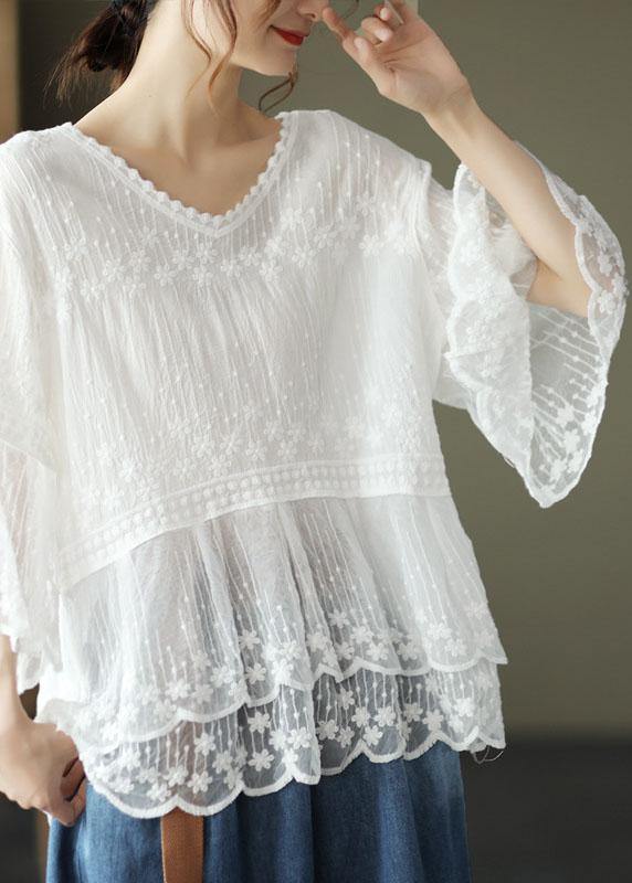 Relaxed fit white women's embroidered blouse, half sleeves, scoop neck, & elegant tiered lace hem. Summer fashion.