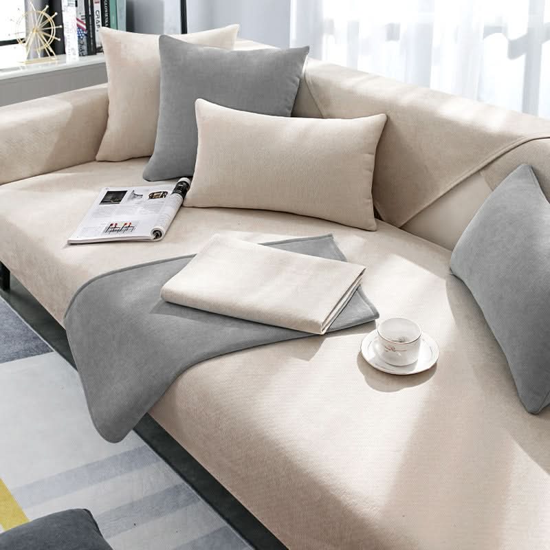 Modern grey sectional sofa cover protecting living room furniture. Durable, pet friendly, washable couch slipcover.