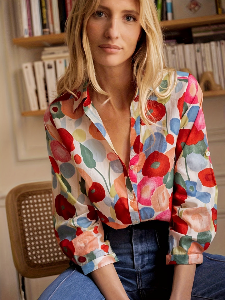 Close-up of women's vibrant collared button-down shirt featuring a unique artistic oversized floral print.